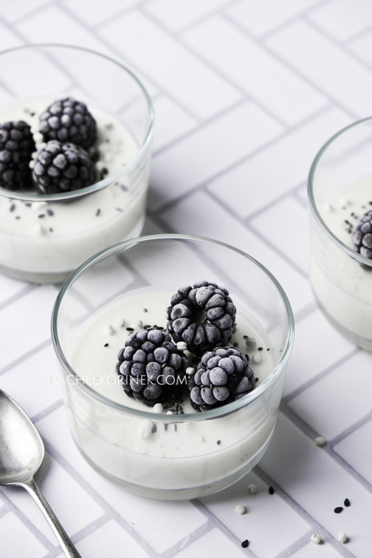 White chocolate panna cotta with frozen blackberries on top. There isn't any colour to this photo so it appears black and white even thought it's real food!