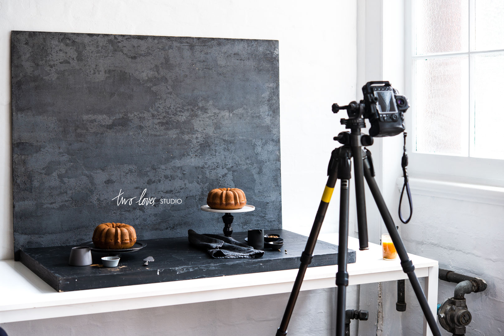 Tripod setup taking photos of bundt cakes in a photography studio