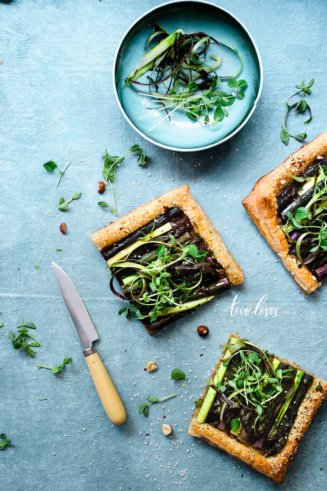 A blue backdrop with a savoury tart. 