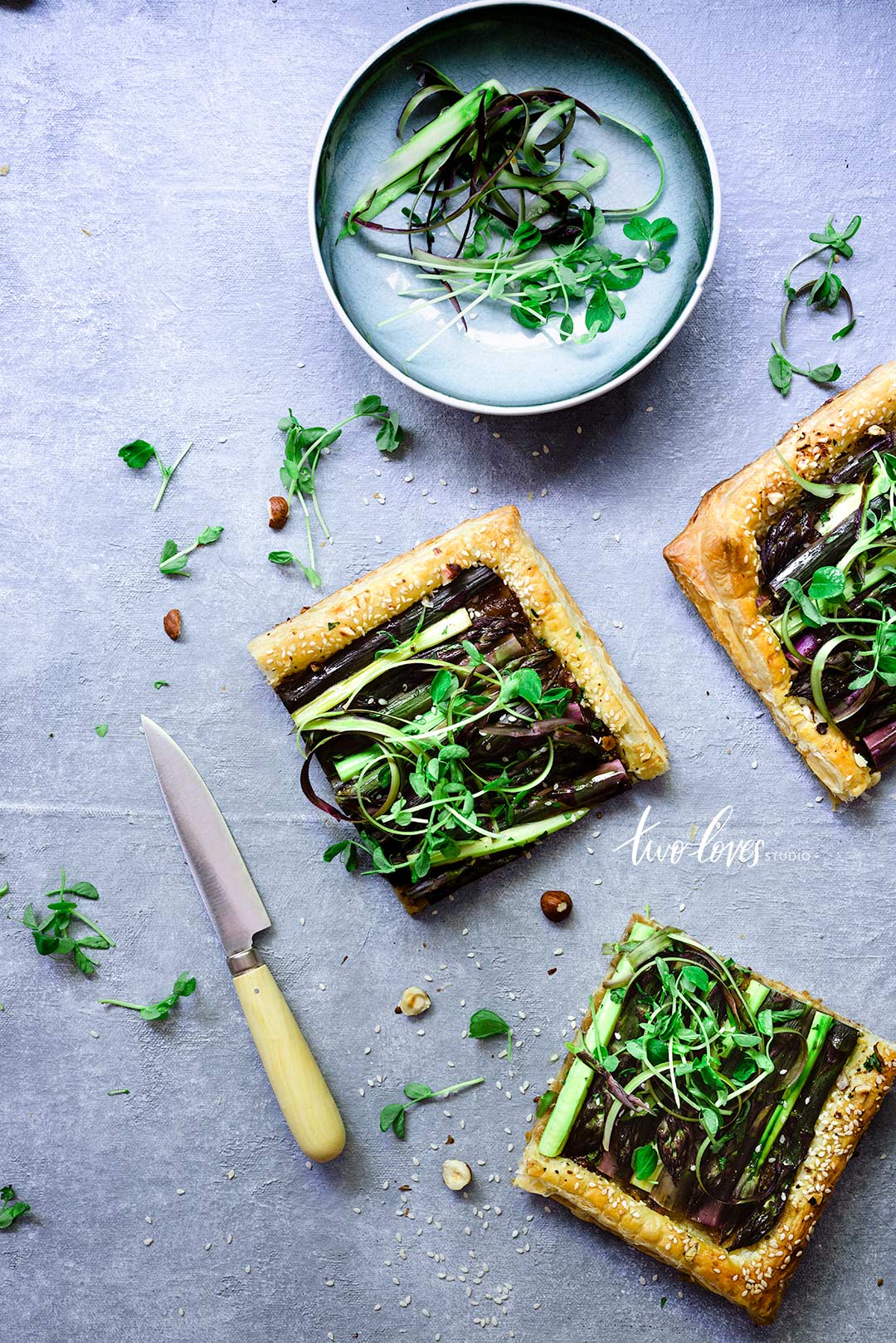 A blue backdrop with a savoury tart. 