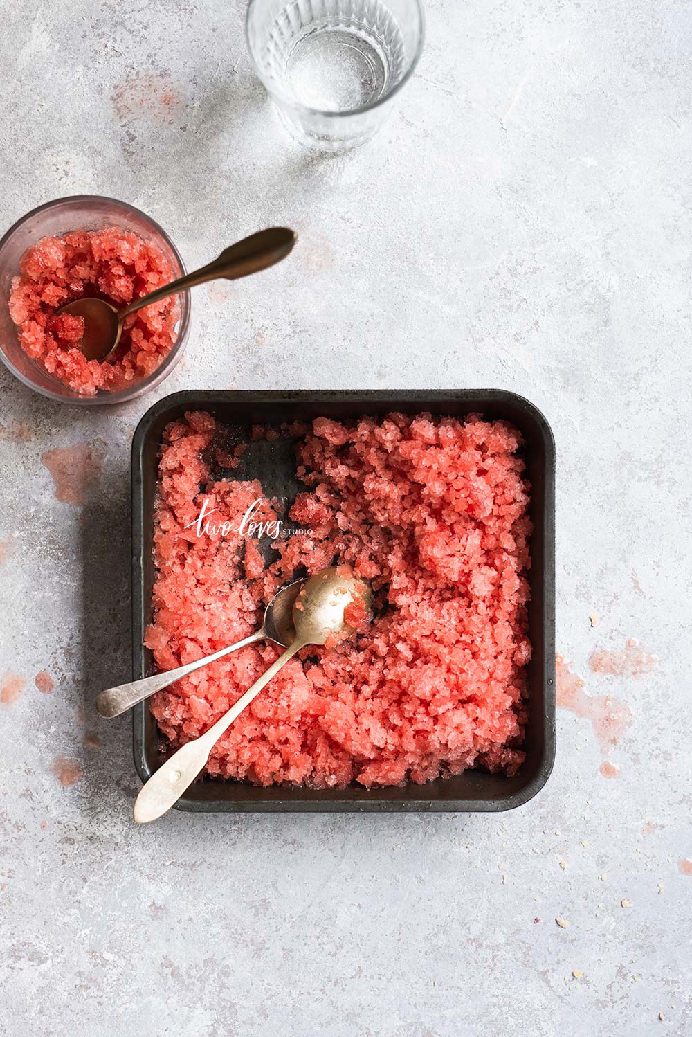 A square dish with a fruit ice mash inside.  