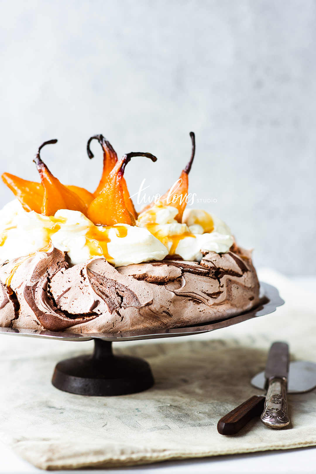 A chocolate meringue with caramelized pears on top  