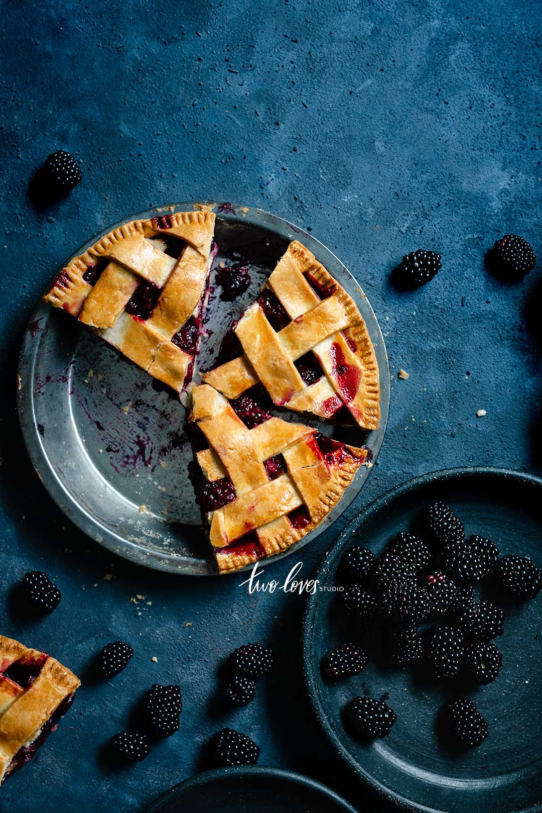 Blackberries in a pie on a dark blue Backdrop. 