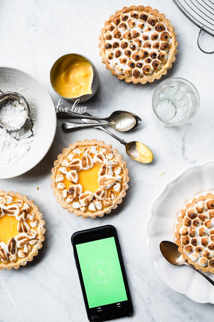 A selection of yellow lemon tarts with meringue topping. 