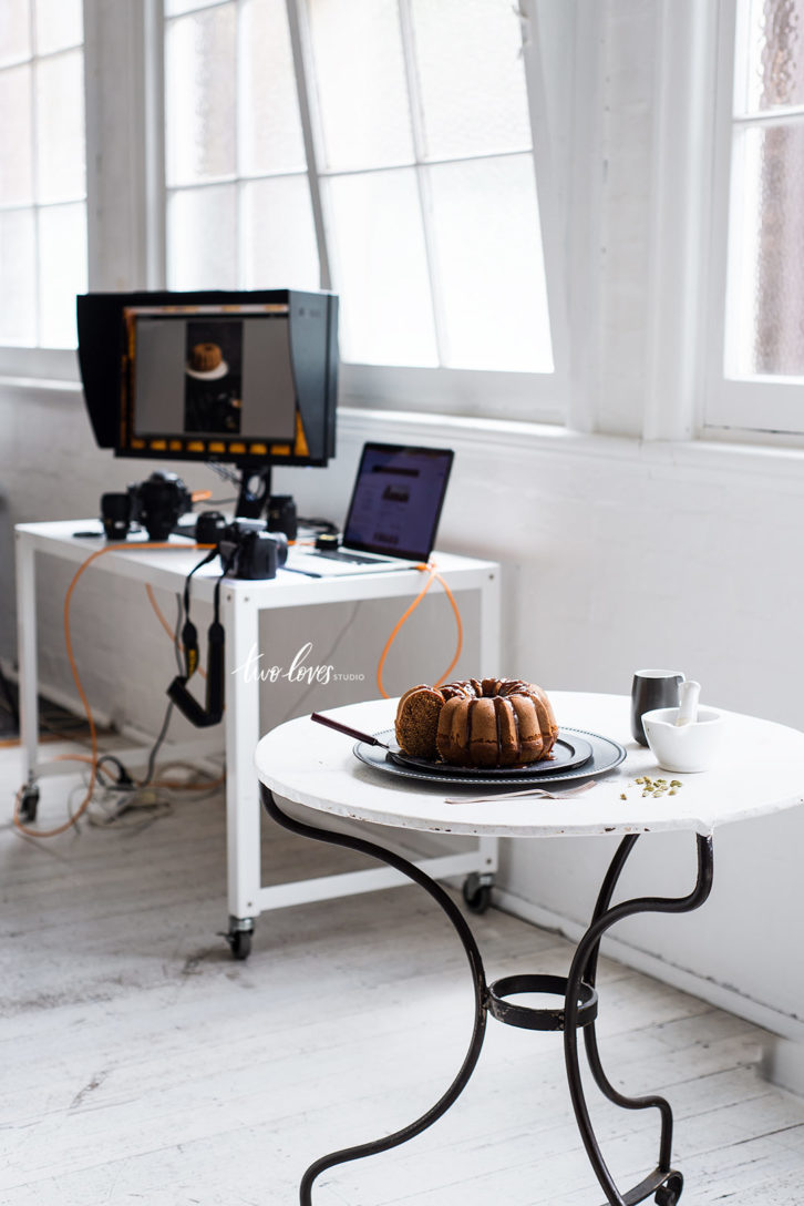 Bundt cake sitting on a plate on a circular table. 