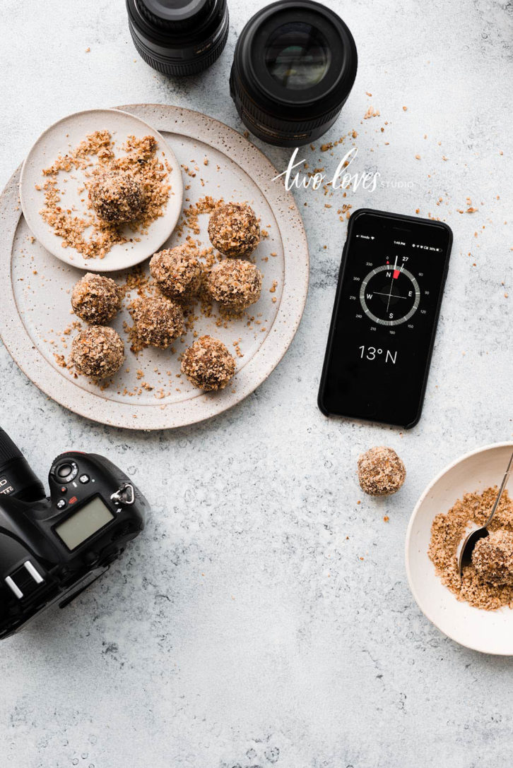 A white plate with treats ontop with a phone.