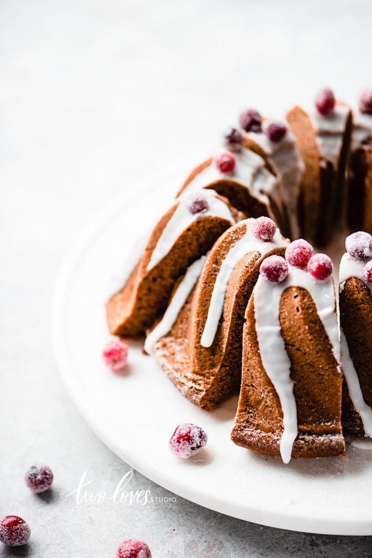 Bundt cake with white frosting and berries