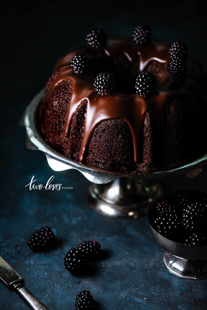 Chocolate bundt cake with a chocolate frosting and berries. 