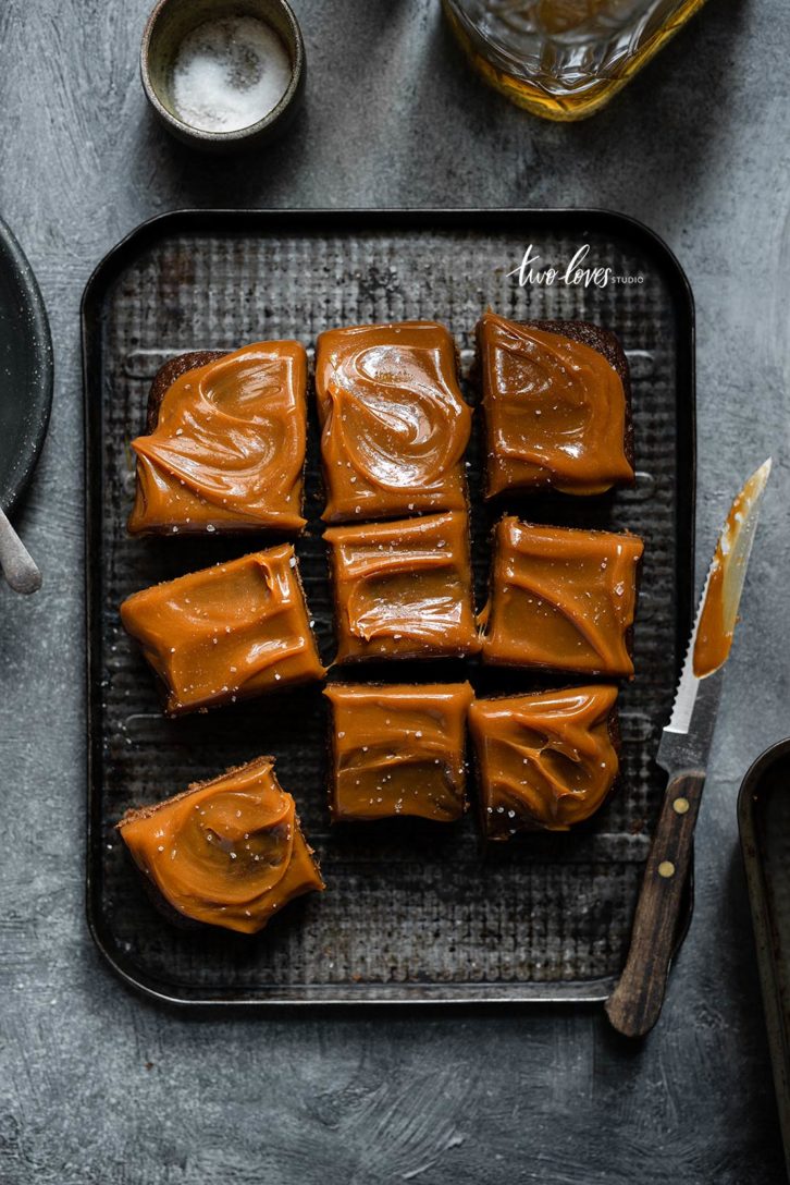 Caramel topped brownie cake cut into slices. 