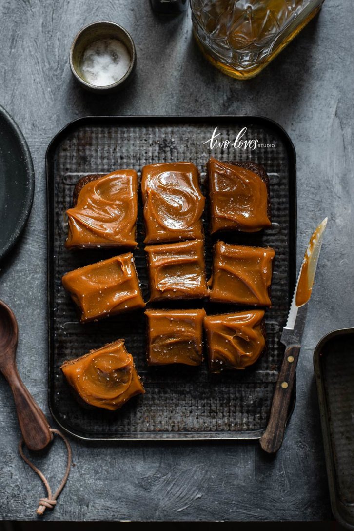 Caramel topped brownie cake cut into slices. 