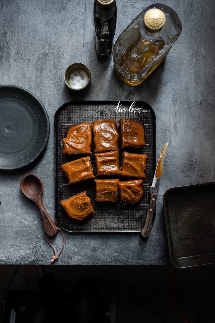 Caramel topped brownie cake cut into slices. 