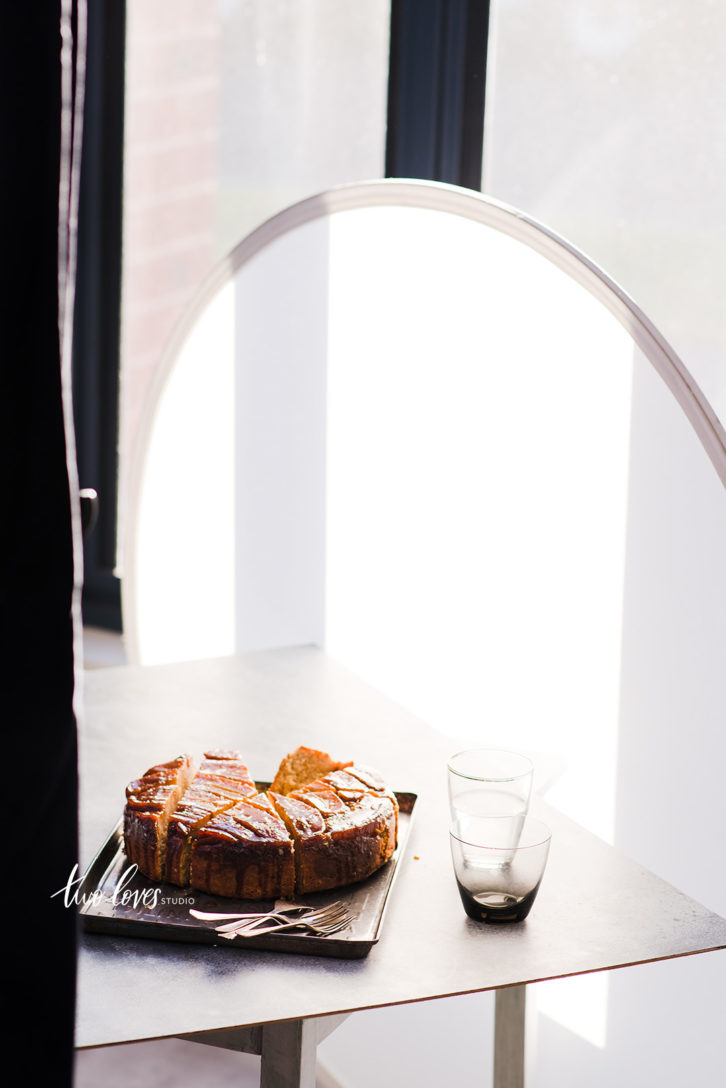 An upside down banana cake with a diffuser for food photography.