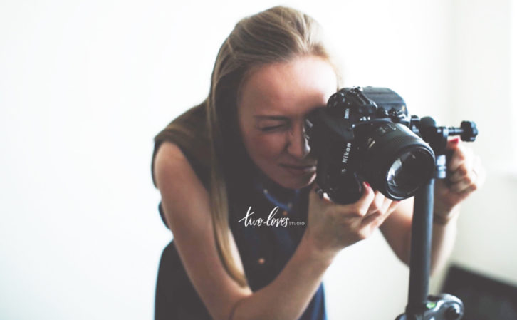 Rachel looking through a camera lense.