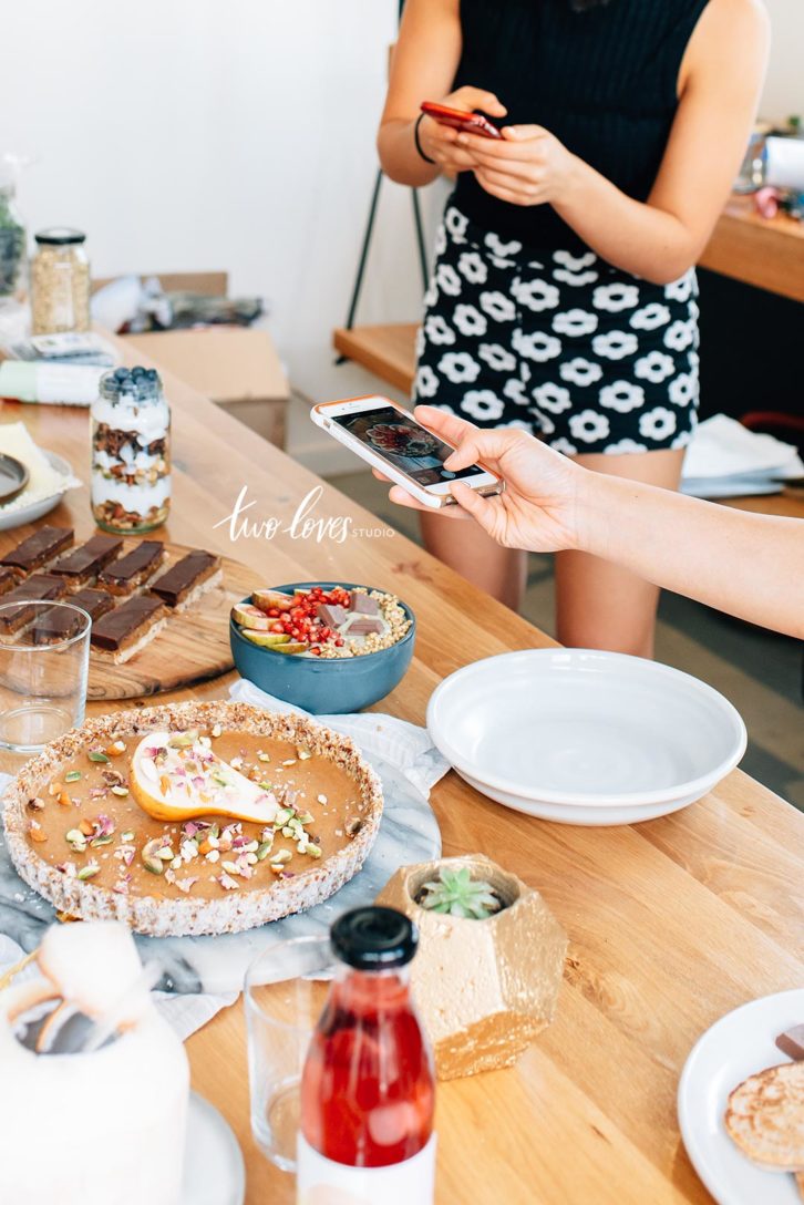 A photo of treats and desserts on a long table. 