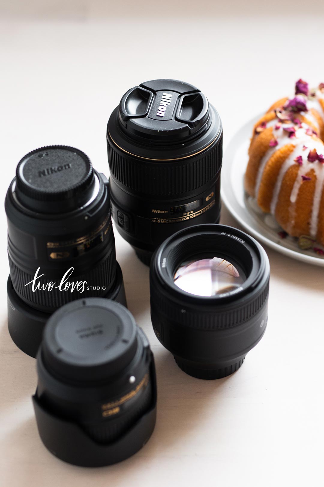 An array of camera lenses with a bundt cake.