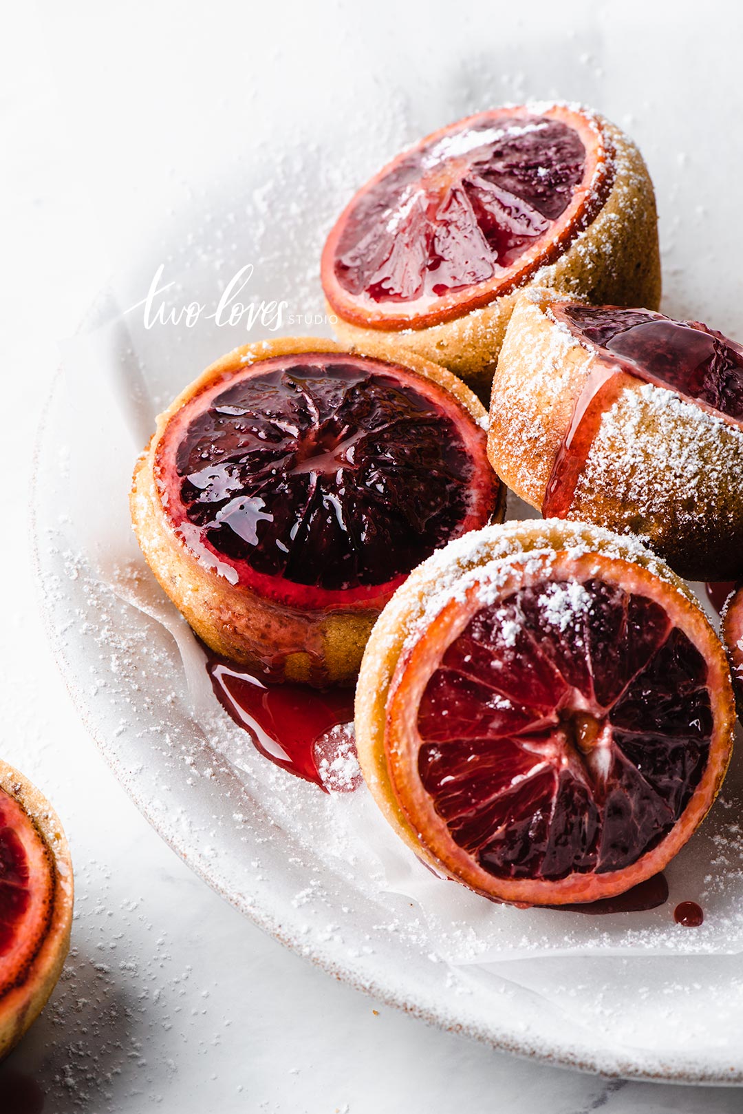 Cupcake cakes with a blood orange topping. 