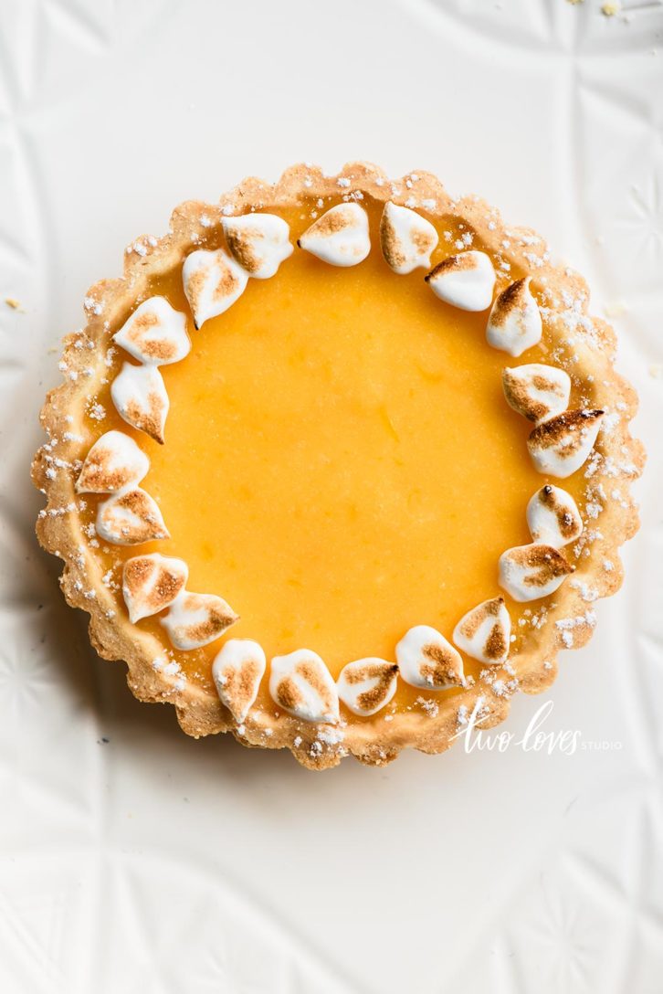 A white dish with a large circle meringue and toasted edges. 