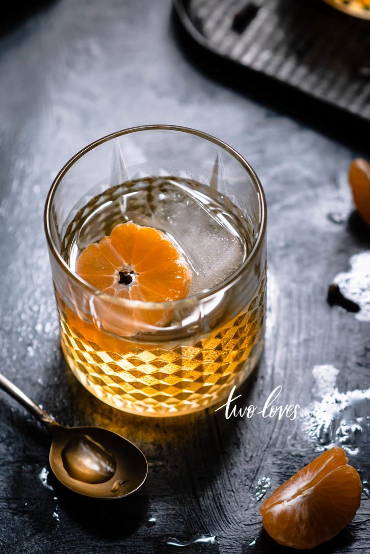 A cocktail glass with a clementine 