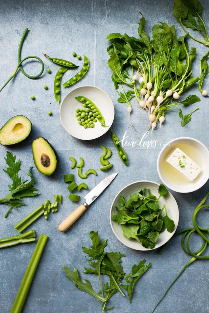 A photo of green vegetables. Avocado, peas, mint and celery. 