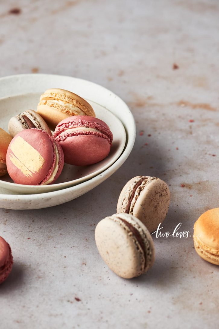 Soft coloured macaroons in a white bowl