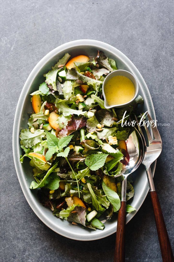 Plate of a salad with a side of dressing