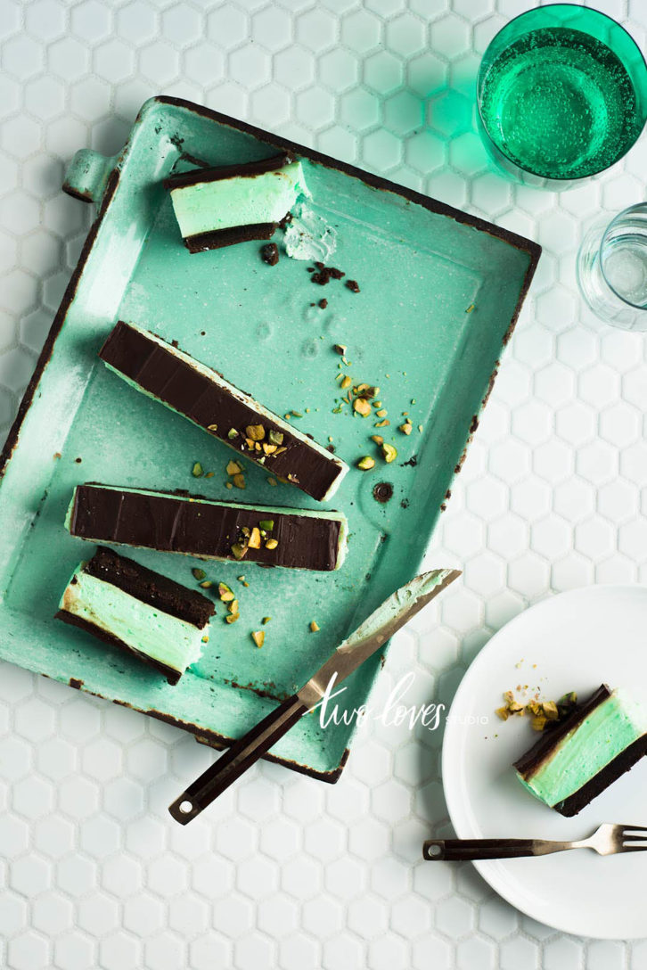 A top view of a chocolate mint slices on a green serving platter  