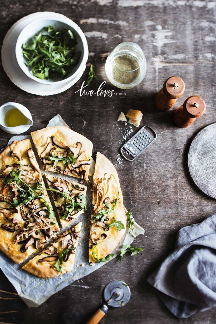 Mushroom Pizza sliced with an assortments of props.