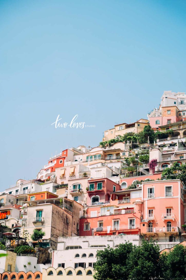 Photo of Italian apartments on a hill taken from the bottom looking up.