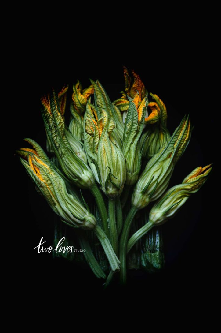 Green vegetables in an arrangement on a black background. 