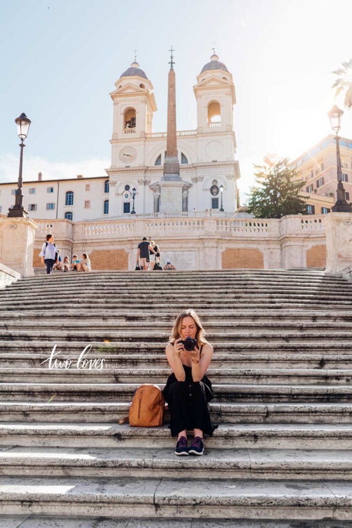 Rachel sitting on a set of large stone steps in Italy.