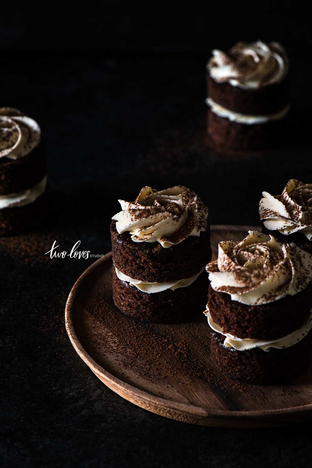 Macro shot of individual mocha cakes in low light food photography.
