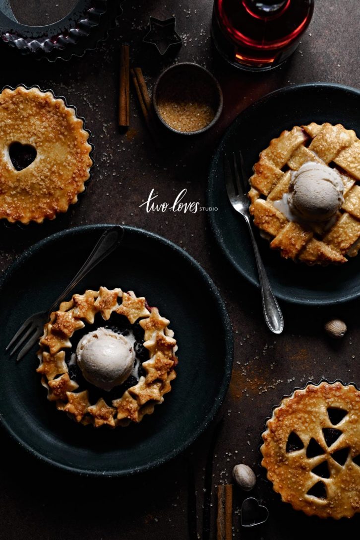 Four mini berry pies with ice-cream. All different details on top. Star wreath, classic criss cross along with heart cutouts and arrows. 