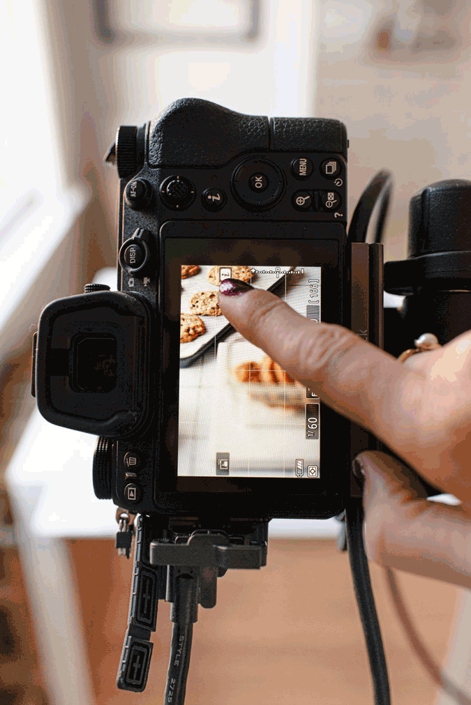GIF of the back of a camera autofocusing on chocolate chip cookies.