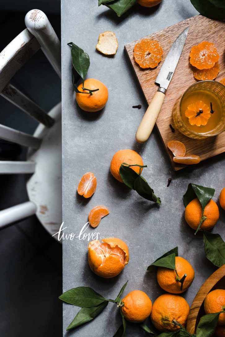 A flatlay of clementines with a chair and table.