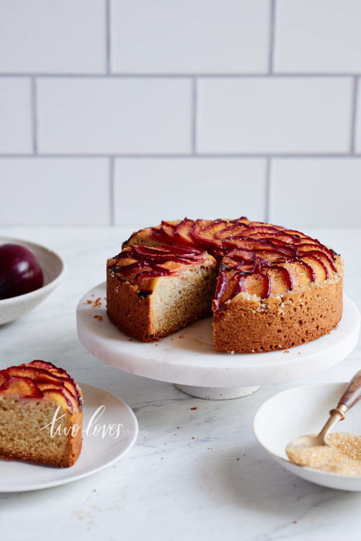 Plum cake on a white diy cake stand. 