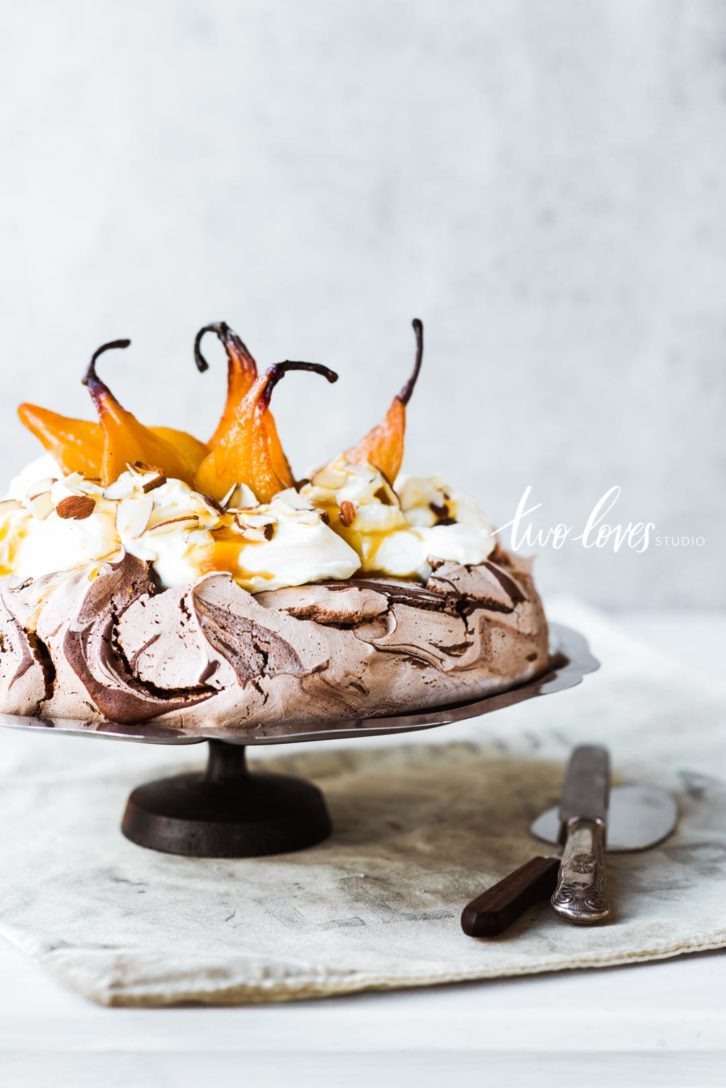 Chocolate swirl pavlova cake with poached pears on a diy cake stand
