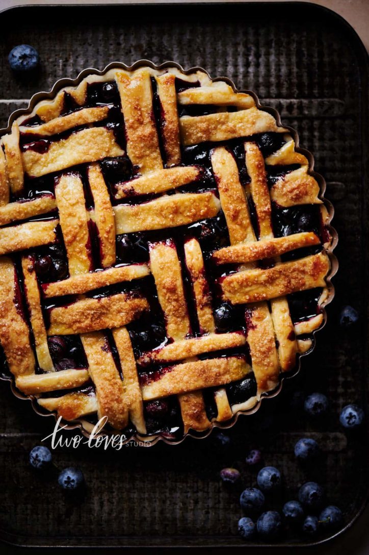 Blueberry pie lattice with juices flowing out.
