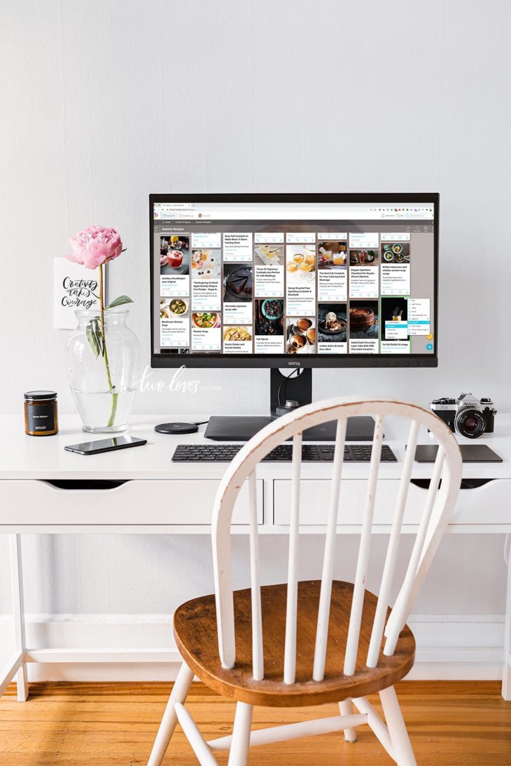 An office desk with chair and computer. The screen is showing how to create a mood board for photography clients.