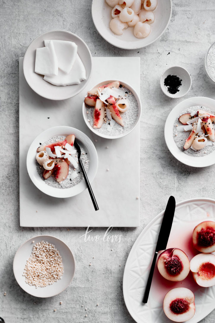 White peaches on top of a chia bowl with coconut shavings.