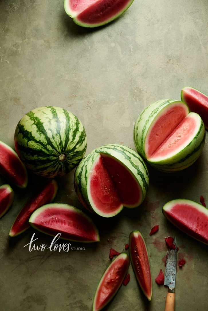 Watermelons with wedges cut out.