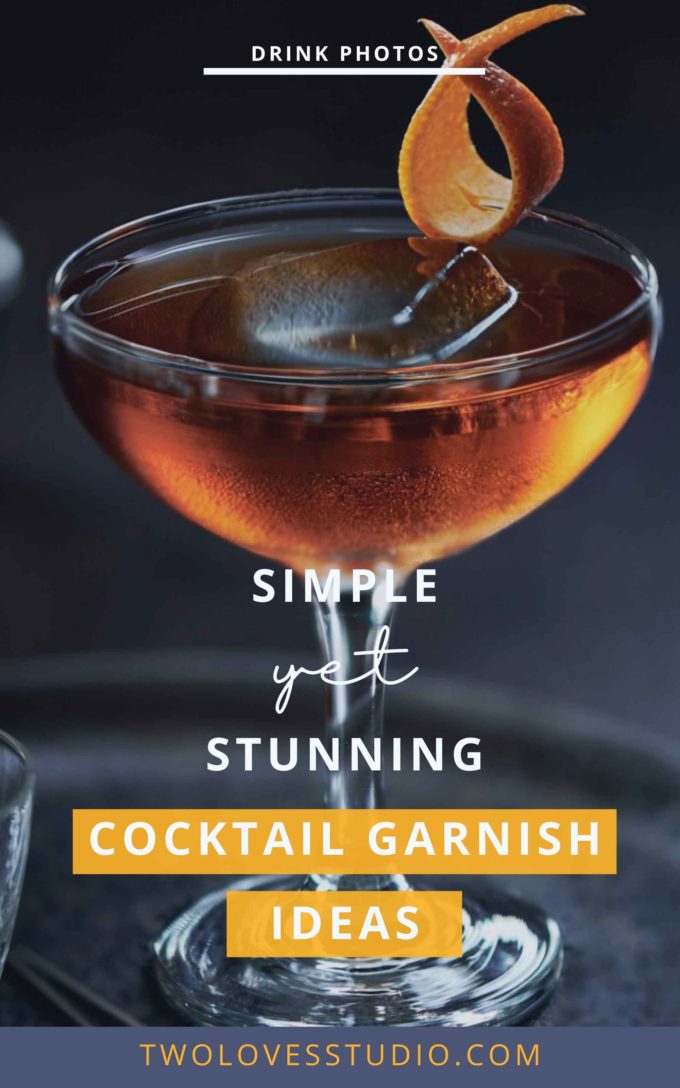 A simple orange ribbon cocktail garnish on the rim of a cocktail on a dark back ground.