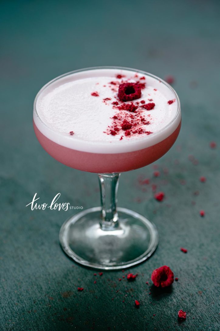 Freeze dried Raspberries sprinkled on top of an egg white foam cocktail. 