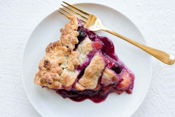 Essential food photography prop example of a matte  white plate and a slice of cherry pie on top. 