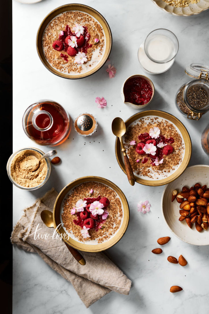 Marble background with bowls on granola and berries. 