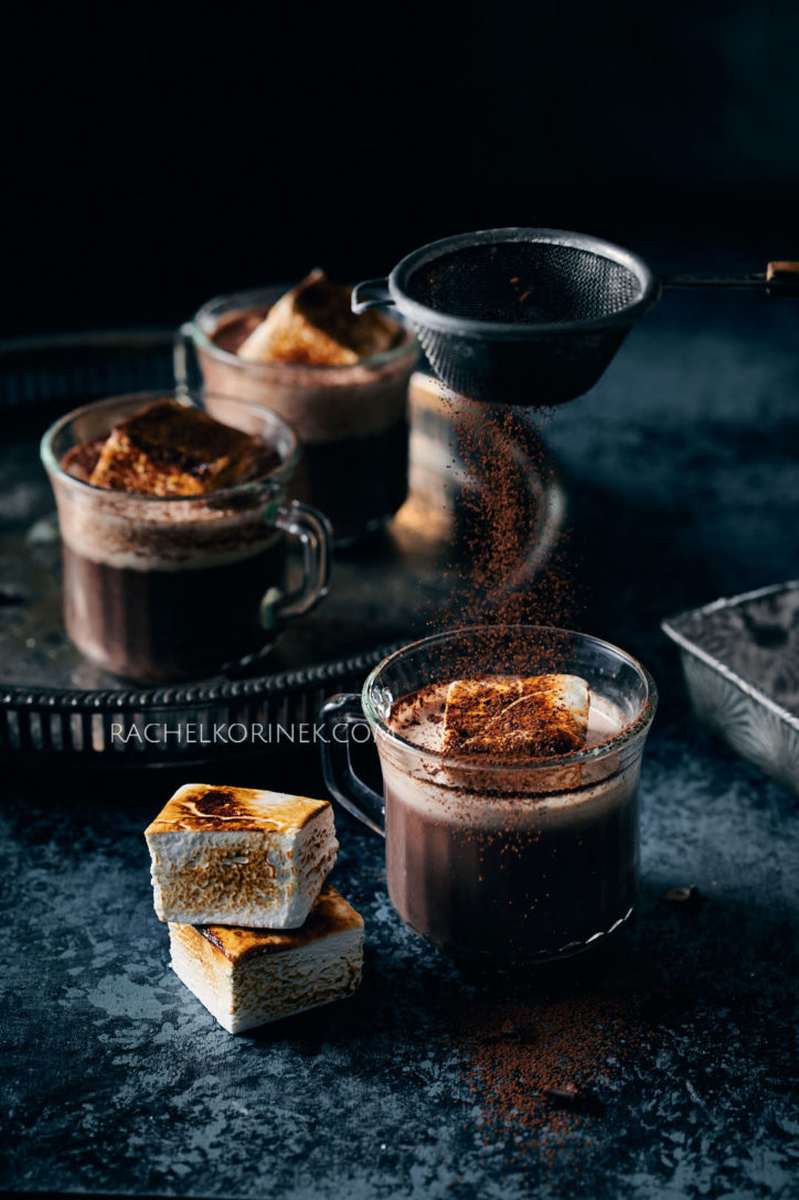 Hot, thick drink textures in photography. Dark blue background with thick rich hot chocolate. 