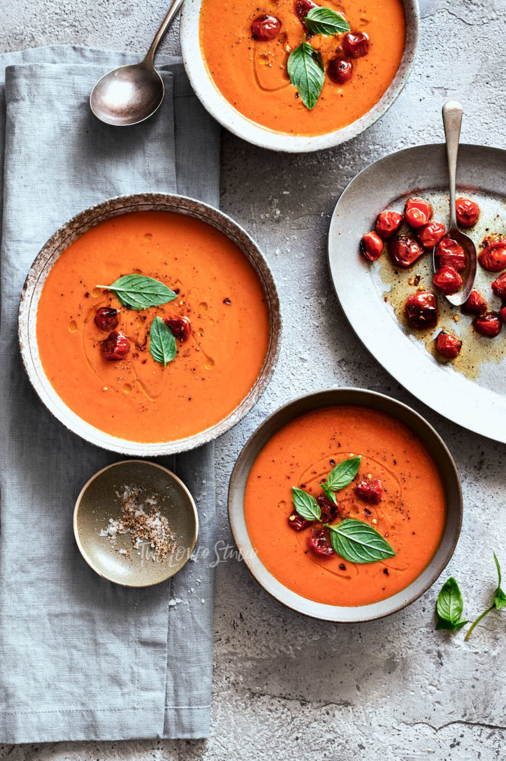 Three bowls of tomato soup with green basil garnishes, before and after photo showing results after retouching photos