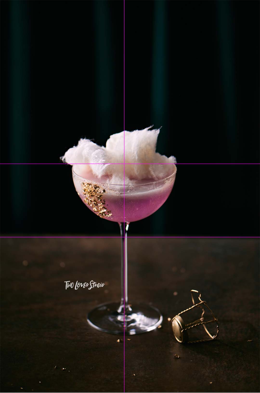 Pink fairy-floss cocktail shot on a brown background. 
