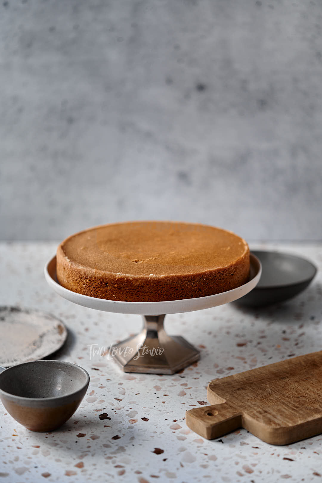 First layer of a walnut cake on a cake stand.