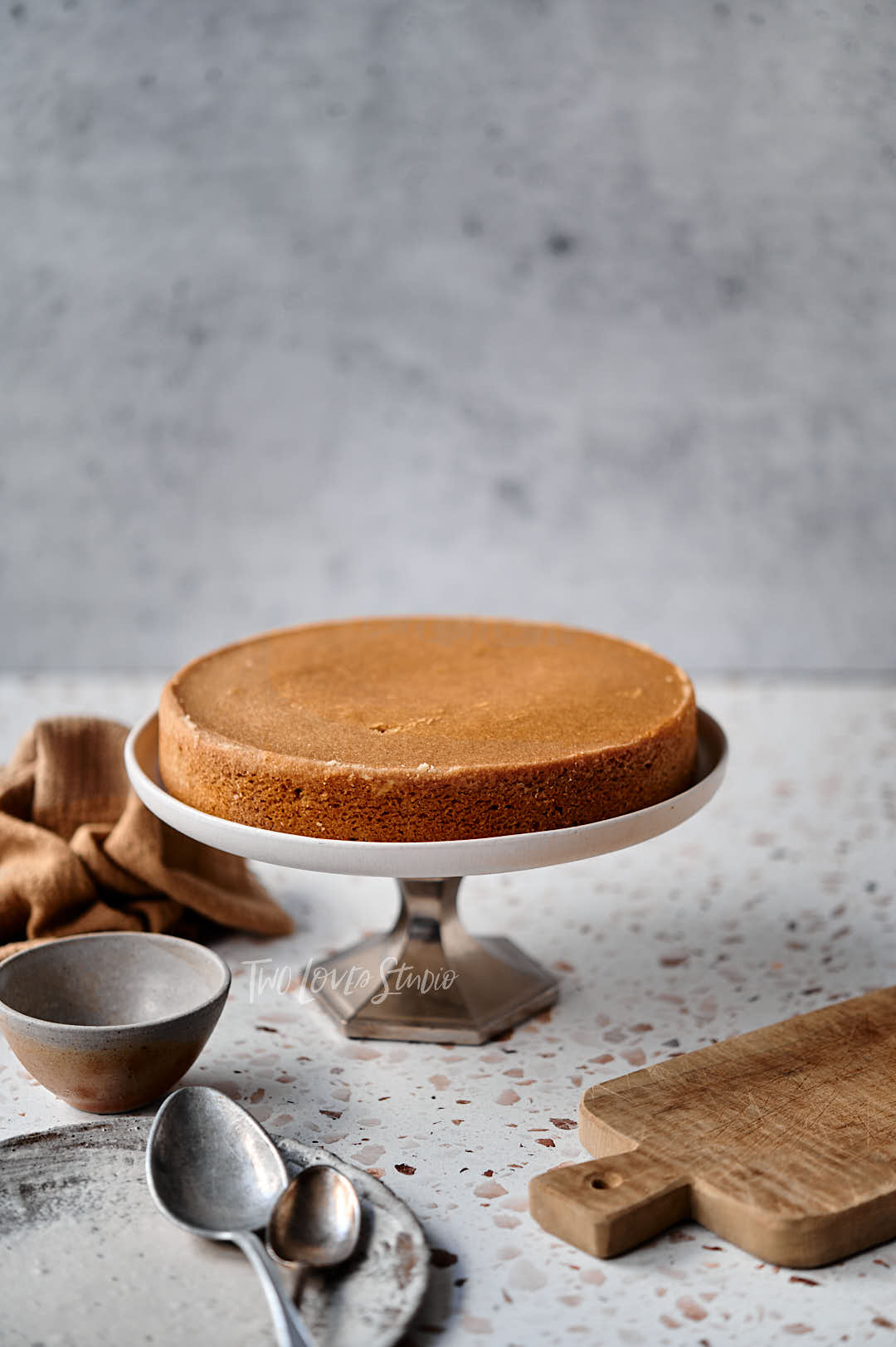 First layer of a walnut cake on a cake stand.