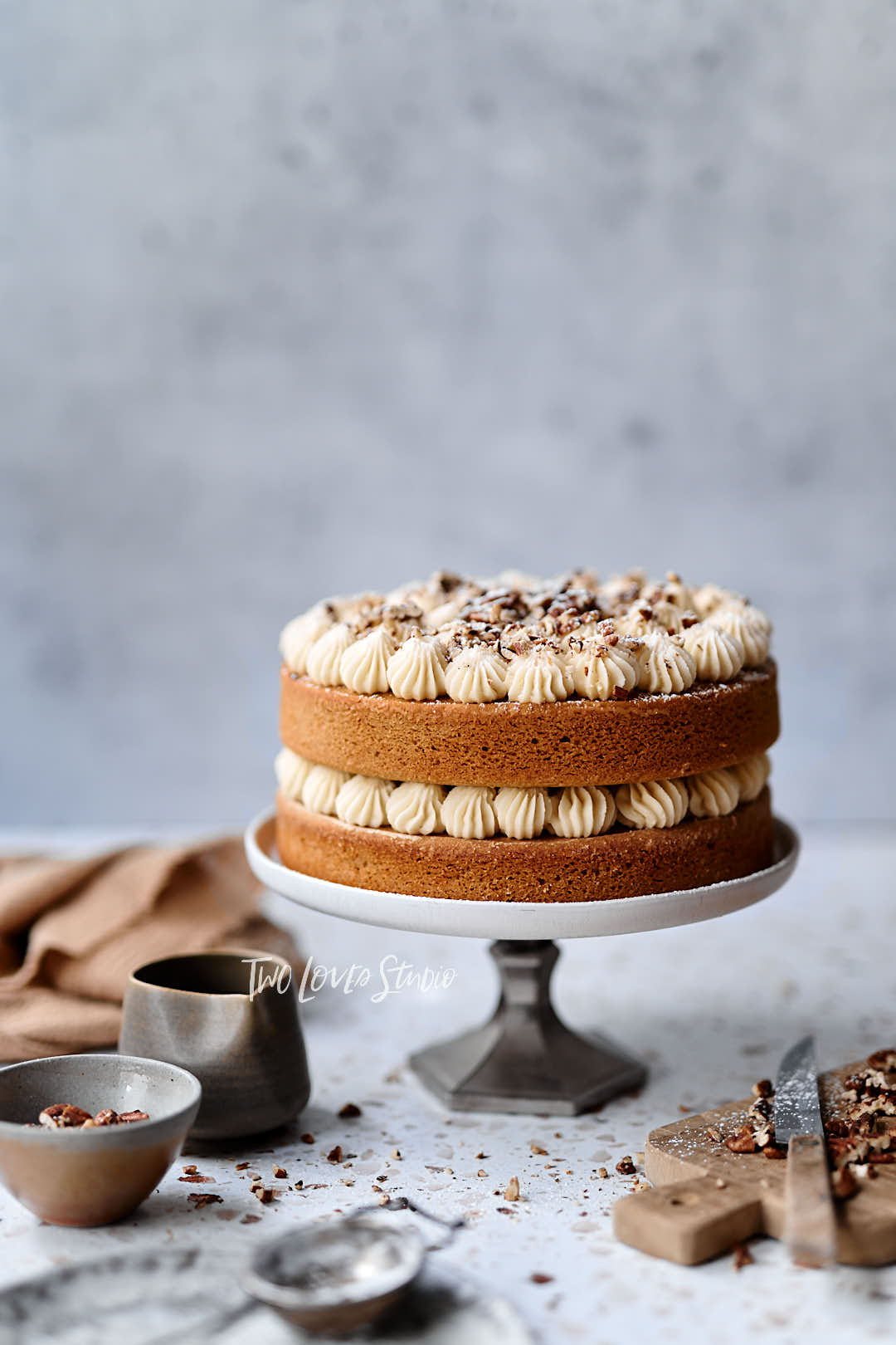 layered walnut cake on a cake stand.